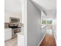 Modern kitchen with stainless steel appliances, white cabinetry, and a mosaic backsplash at 2614 Cove Cay Dr # 301, Clearwater, FL 33760