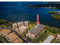 Aerial view of waterfront condo building on scenic coastline with lush landscaping at 2700 Bayshore Blvd # 9209, Dunedin, FL 34698