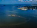 Expansive aerial view of waterfront homes nestled on a picturesque coastline at 2700 Bayshore Blvd # 9209, Dunedin, FL 34698