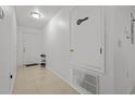Bright entryway featuring tile floors, a white front door, storage space and modern lighting at 2819 N 75 St, Tampa, FL 33619