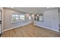 Bright living room featuring wood-look floors, fresh paint, and great natural light at 3241 Williamsburg St, Sarasota, FL 34231
