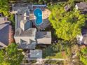 Aerial view of house showing the backyard with pool and lush landscaping on a sunny day at 3313 W Mullen Ave, Tampa, FL 33609