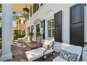 Charming front porch with brick floor and comfortable seating area, perfect for enjoying the outdoors at 3313 W Mullen Ave, Tampa, FL 33609