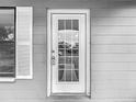Close-up of the front door with a glass window and security features at 3407 N 48Th St, Tampa, FL 33605