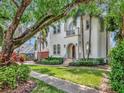 Elegant two-story home with a lush lawn, mature trees, and a beautiful Mediterranean-style facade at 511 Erie Ave, Tampa, FL 33606