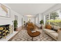 Bright living room with fireplace, hardwood floors, neutral furniture, and large windows at 615 14Th Ne Ave, St Petersburg, FL 33701