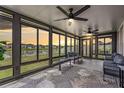 Bright sunroom featuring floor to ceiling windows, ceiling fans, and comfortable seating at 8749 Parsons Hill Blvd, Wesley Chapel, FL 33545