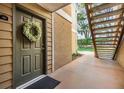 Stylish front door with a wreath and stairs leading up to the second floor at 9481 Highland Oak Drive # 602, Tampa, FL 33647