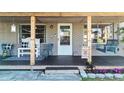 Charming front porch with swing and chairs offers a cozy welcome at 9616 Oak Ridge Ave, Riverview, FL 33578