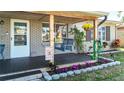 Inviting front porch with a swing and decorative flower accents at 9616 Oak Ridge Ave, Riverview, FL 33578