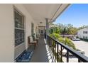 Exterior balcony with seating and view of the community at 100 Glennes Ln # 207, Dunedin, FL 34698