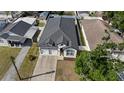 A pristine home featuring a new roof and a well-kept lawn, captured from an aerial view at 1423 W Wood St, Tampa, FL 33604