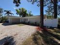 Single-story home with a well-maintained yard and driveway with attractive gravel landscaping at 1779 Sunset Point Rd, Clearwater, FL 33755