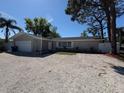 Single-story home with a well-maintained yard, driveway, and attached garage in a great neighborhood at 1779 Sunset Point Rd, Clearwater, FL 33755