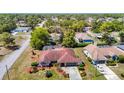 Areal view of home with screened in pool, landscaping, and two-car garage at 2017 Godfrey Ave, Spring Hill, FL 34609