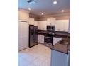 Well-equipped kitchen with stainless steel appliances, granite countertops, and ample white cabinetry at 2136 Cerulean Sky Way, Lutz, FL 33558