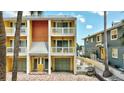 Charming two-story exterior showcasing unique architecture, a brick driveway, and garage at 234 Dolphin Pt # 1, Clearwater Beach, FL 33767