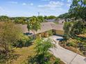Charming home featuring a well-maintained lawn, a driveway, and mature trees and landscaping at 2904 Pointer Pl, Seffner, FL 33584