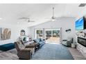 Bright living room with vaulted ceilings, waterfront views, comfortable seating, fireplace, and desk area at 321 Bahia Vista Dr, Indian Rocks Beach, FL 33785