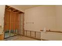 Partially demoed bathroom with exposed framing, offering remodeling potential at 39696 Meadowood Loop, Zephyrhills, FL 33542