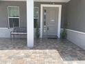 Inviting front porch with brick pavers and seating bench at 4007 W Gray St, Tampa, FL 33609