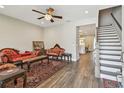 Elegant living room boasts hardwood floors, a ceiling fan, and a staircase at 4007 W Gray St, Tampa, FL 33609
