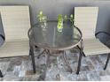 Outdoor patio seating area with a round table and two chairs, perfect for relaxing at 4007 W Gray St, Tampa, FL 33609