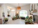 Bright foyer with tile floors, arched doorways, lots of plants, and natural light at 4444 Boyer Ter, North Port, FL 34288