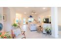 Spacious open-concept living room with neutral tones, light wood flooring, and modern furnishings at 4444 Boyer Ter, North Port, FL 34288