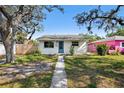 Charming single story home with blue door, white paint and well manicured yard at 4701 14Th S Ave, St Petersburg, FL 33711