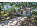 Charming single-story home featuring light grey siding and a well-maintained front yard at 503 W Lee St, Plant City, FL 33563