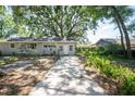 Charming single-story home featuring light grey siding and a well-maintained front yard at 503 W Lee St, Plant City, FL 33563