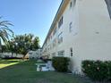 Multi-story condo exterior with well-maintained landscaping and mature trees at 5750 80Th N St # B203, St Petersburg, FL 33709