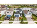 Beautiful two-story home with a manicured lawn, attached garage, close to a pond and neighboring houses at 7334 Ashcroft Dr, Wesley Chapel, FL 33545