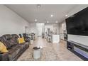 Open-concept living room flows into a kitchen with modern appliances and a dining area, perfect for entertaining at 7334 Ashcroft Dr, Wesley Chapel, FL 33545