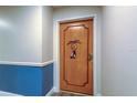 Condo entrance door with a wooden design and a decorative wreath at 80 Rogers St # 2A, Clearwater, FL 33756
