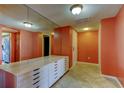 Spacious walk-in closet with mirrored walls and ample storage at 80 Rogers St # 2A, Clearwater, FL 33756