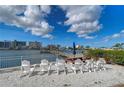 A lakeside picnic area with picnic table, lounge chairs and shady vegetation at 10190 Imperial Point W Dr # 8, Largo, FL 33774