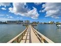 Picturesque view down the wooden pier leading to the beautiful bay with clear skies above, offering a peaceful waterfront experience at 10190 Imperial Point W Dr # 8, Largo, FL 33774