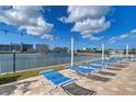 Inviting pool deck with comfortable lounge chairs and string lights, offering a perfect spot for relaxation and enjoyment of the waterfront view at 10190 Imperial Point W Dr # 8, Largo, FL 33774