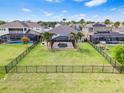 Expansive fenced-in backyard with a screened-in pool, lush lawn, and mature landscaping at 11851 Lake Lucaya Dr, Riverview, FL 33579