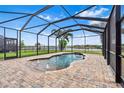 Inviting screened-in pool area with stone pavers, water features, and ample space for outdoor lounging at 11851 Lake Lucaya Dr, Riverview, FL 33579