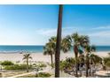 Scenic beach view with palm trees and outdoor seating creating a relaxing beachfront ambiance at 1390 Gulf Blvd # 104, Clearwater, FL 33767