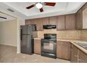 Efficient kitchen with a stainless refrigerator, stove, and dark wood cabinetry at 1421 Normandy Park Dr # 6, Clearwater, FL 33756