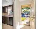View of the kitchen from the entryway featuring stainless appliances and ample counter space at 1421 Normandy Park Dr # 6, Clearwater, FL 33756