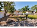 Inviting single-story home with fresh exterior, a charming walkway, and a well-maintained front yard at 217 50Th N Ter, St Petersburg, FL 33703