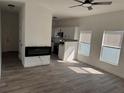 Bright living room with modern electric fireplace, wood floors, and open to the kitchen at 2527 13Th S Ave, St Petersburg, FL 33701