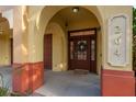 Exterior entrance with an arched doorway, a wooden door with glass panes and sidelights at 264 Seagate Ct, Dunedin, FL 34698