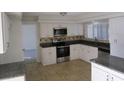 Well-appointed kitchen with granite countertops, stainless steel appliances, and ample white cabinetry, perfect for cooking at 4118 Dellbrook Dr, Tampa, FL 33624
