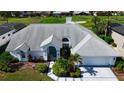 Aerial view of a well-maintained single-Gathering home with a manicured lawn and golf course in the background at 4228 Presidential Avenue E Cir, Bradenton, FL 34203